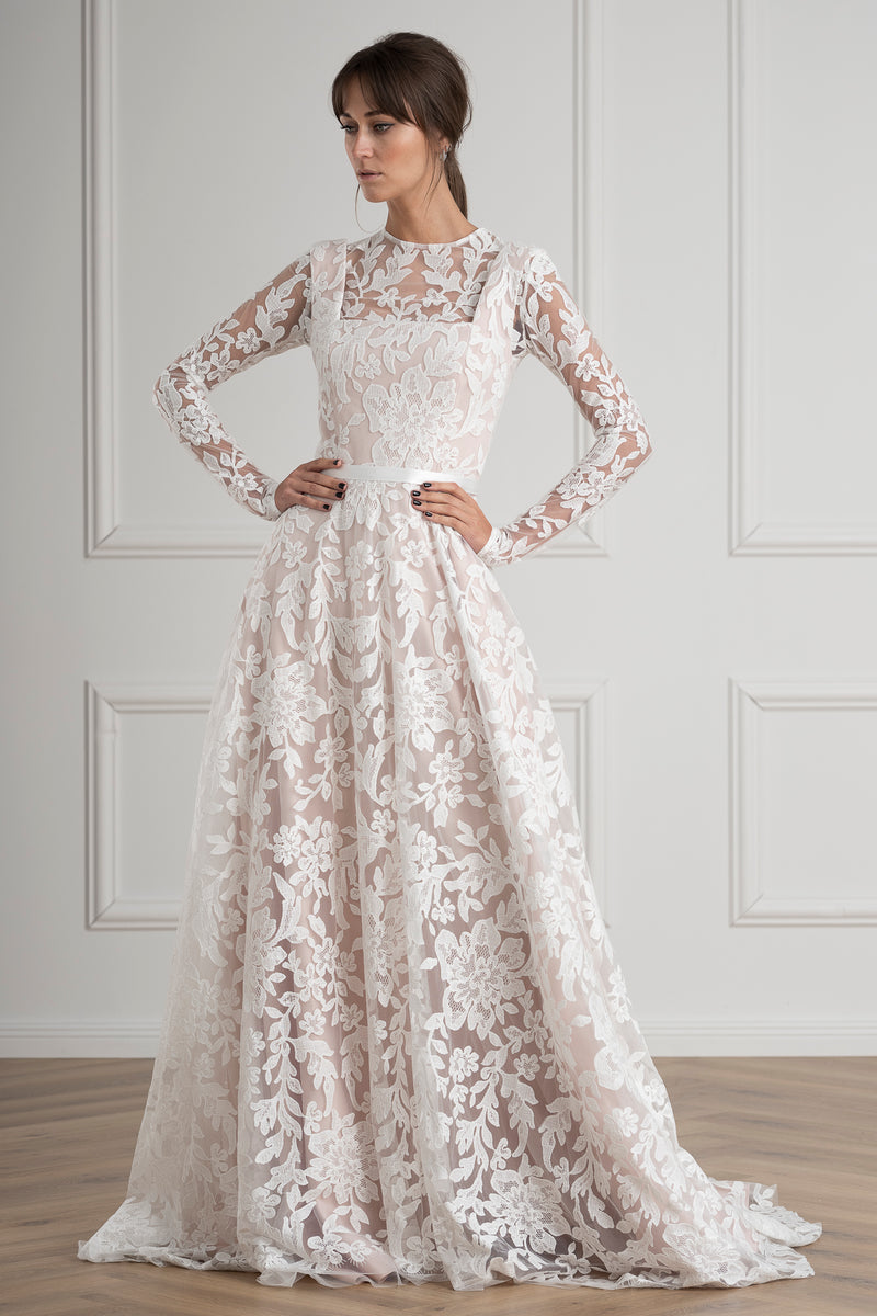 bride wearing a white lace modest wedding dress with long sleeves boho style bride vintage wedding dress classic bride elegant wedding dress 